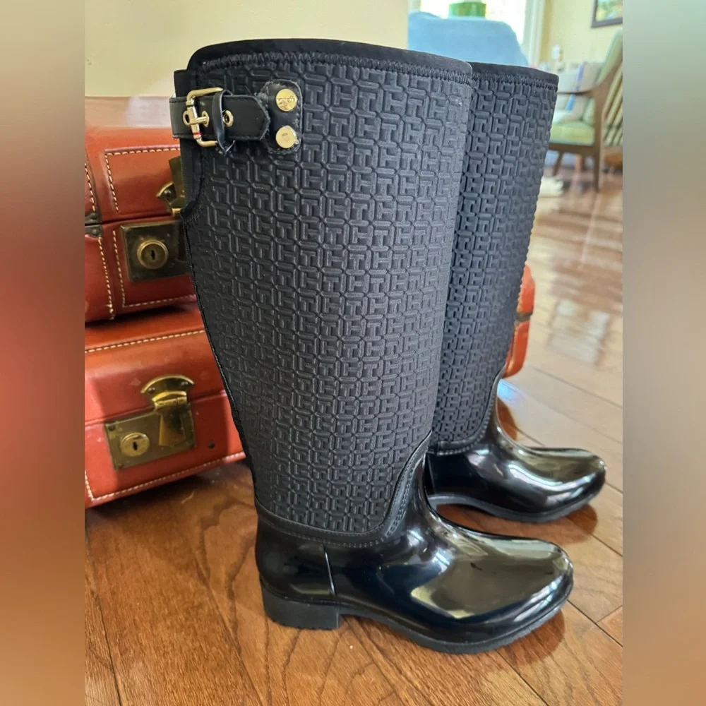 Tommy Hilfiger Black Boots. Gold accent hardware, logo embossed fabric.